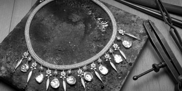 Handmade necklace arranged with jeweler's tools